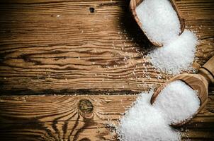 Salt background . On wooden table. photo