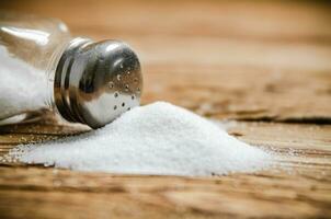 Salt background . On wooden table. photo