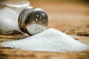 Salt background . On wooden table. photo