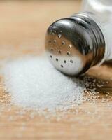 Salt background . On wooden table. photo