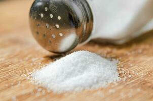 Salt background . On wooden table. photo