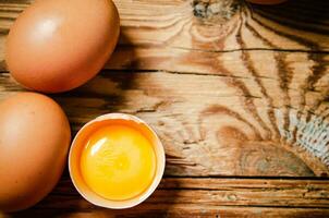 Chicken eggs on wooden table. photo