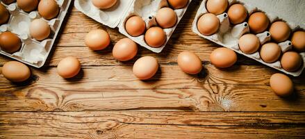 Chicken eggs on wooden table. photo