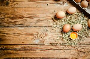 Chicken eggs on wooden table. photo