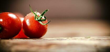 Fresh tomatoes. On wooden table. photo