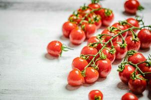 Fresh tomatoes. On white table. photo