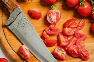 Fresh chopped tomatoes. On cutting board. photo