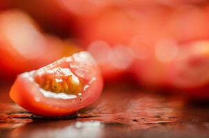 Fresh chopped tomatoes. On black table. photo