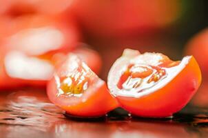 Fresh chopped tomatoes. On black table. photo