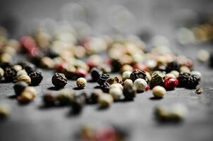 Peppercorn on rustic background. photo