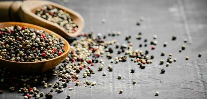 Peppercorn on rustic background. photo