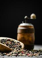 Peppercorn on rustic background. photo