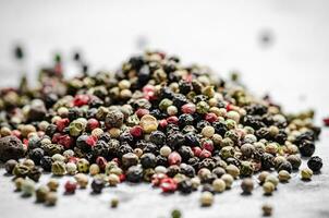 Peppercorn on rustic background. photo