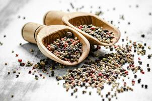 Peppercorn on rustic background. photo