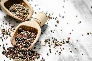 Peppercorn on rustic background. photo