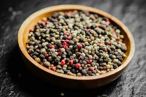 Peppercorn on rustic background. photo