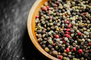 Peppercorn on rustic background. photo