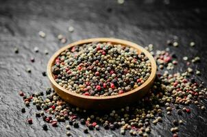 Peppercorn on rustic background. photo