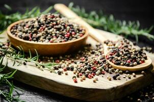 Peppercorn on rustic background. photo