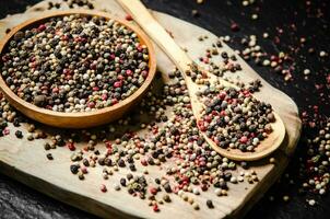 Peppercorn on rustic background. photo