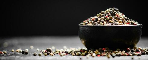 Peppercorn on rustic background. photo