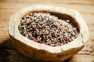 Peppercorn on rustic background. photo