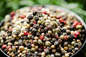 Peppercorn on rustic background. photo