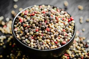 Peppercorn on rustic background. photo