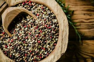 Peppercorn on rustic background. photo