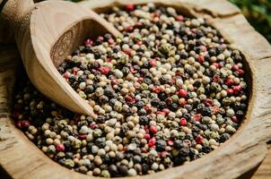 Peppercorn on rustic background. photo