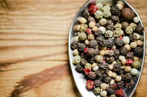 Peppercorn on rustic background. photo