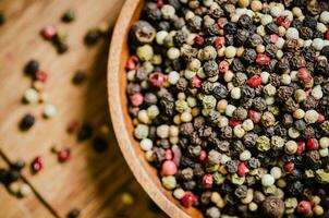 Peppercorn on rustic background. photo