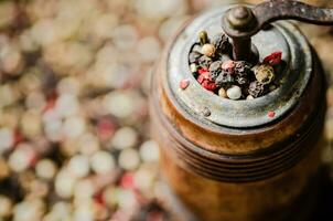 Peppercorn on rustic background. photo