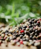 Peppercorn on rustic background. photo