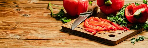 Chopped sweet pepper. On wooden table. photo