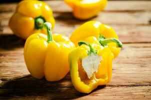 Fresh sweet pepper. On wooden table. photo