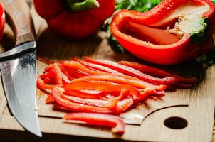 Chopped sweet pepper. On wooden table. photo