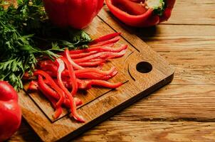 Chopped sweet pepper. On wooden table. photo