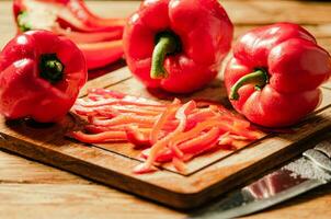 Chopped sweet pepper. On wooden table. photo