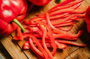 Chopped sweet pepper. On wooden table. photo