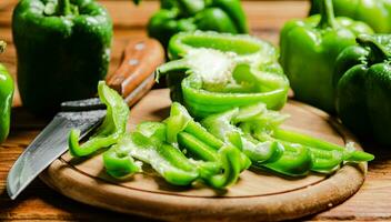 Chopped sweet pepper. On wooden table. photo