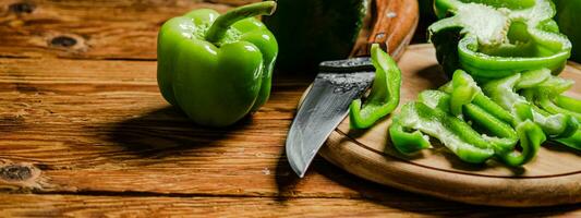 Chopped sweet pepper. On wooden table. photo