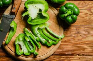 Chopped sweet pepper. On wooden table. photo