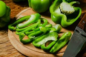 Chopped sweet pepper. On wooden table. photo