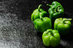 Fresh sweet pepper. On black table. photo