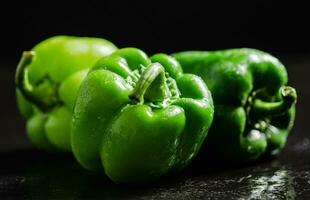 Fresh sweet pepper. On black table. photo