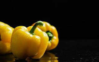 Fresh sweet pepper. On black table. photo