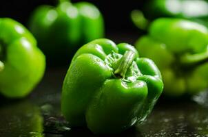 Fresh sweet pepper. On black table. photo