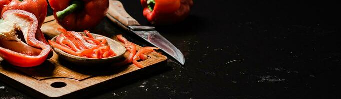 Chopped sweet pepper. On black table. photo