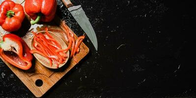 Chopped sweet pepper. On black table. photo